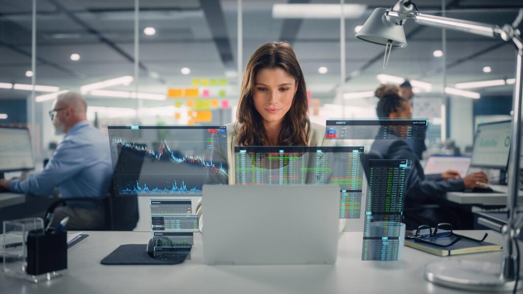 Photo of a woman working on Applied Artificial Intelligence on a computer