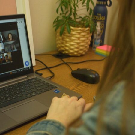 A St. Scholastica staff member in a video conference