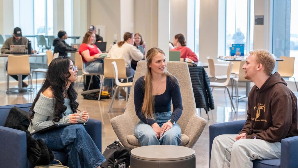 Group of St. Scholastica students chatting in the Student Center.
