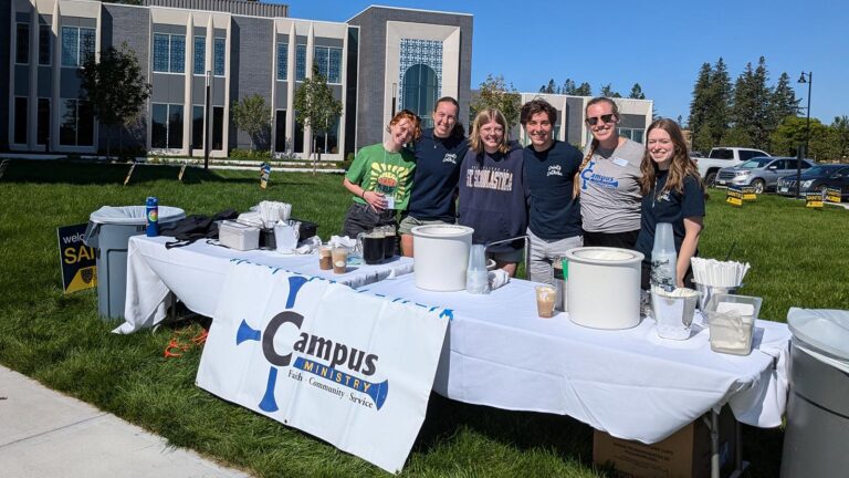 A group poses at a St. Scholastica Campus Ministry Event