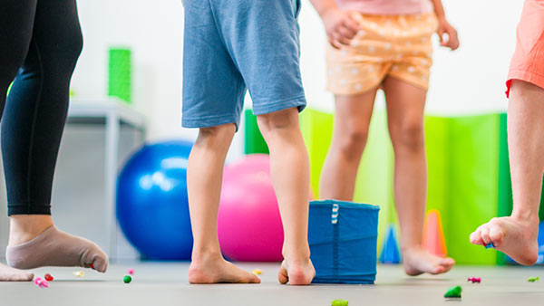 Occupational Therapist works with children on motor skills through a game