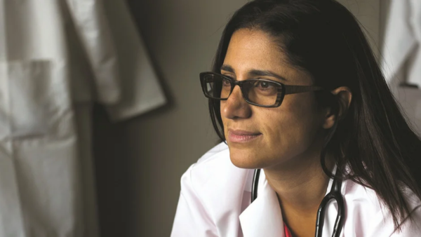Dr. Mona Hanna-Attisha pictured. Woman with dark hair and glasses wearing a doctor's coat.