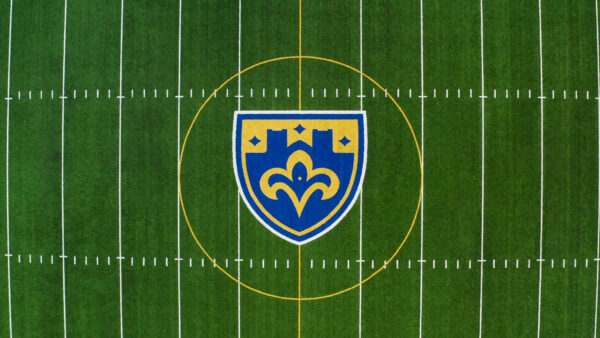 Aerial view of Kenny Harkins Field, featuring the St. Scholastica Athletics logo