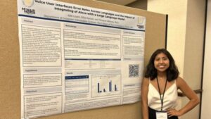 Allie Lopez stands in front of her research poster.