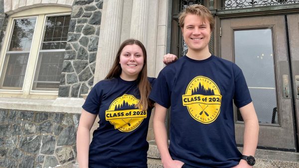 St. Scholastica students standing in front of Tower Hall wearing Class of 2026 t-shirts.