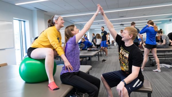 St. Scholastica students learning physical therapy techniques in the Mat Lab.