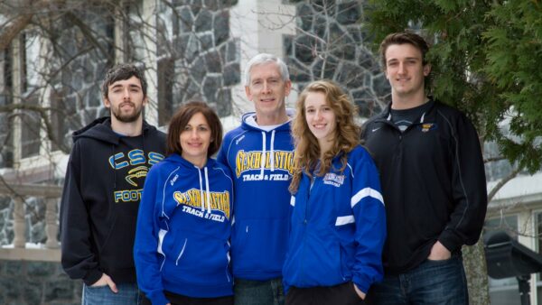 Kaplan family standing in front of Tower Hall on the St. Scholastica campus.
