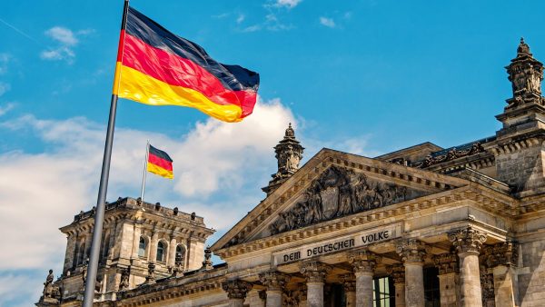 A German flag in front of a building.