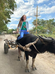 St. Scholastica graduate Kathryne Ford riding an ox