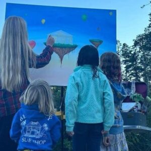 St. Scholastica alum, Kathryne Ford, paints for an audience of little kids