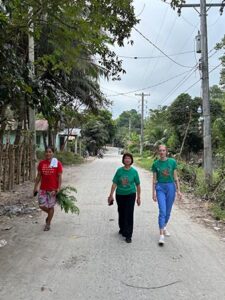 St. Scholastica alum Kathryne Ford walks with a coworker in the Philippines.