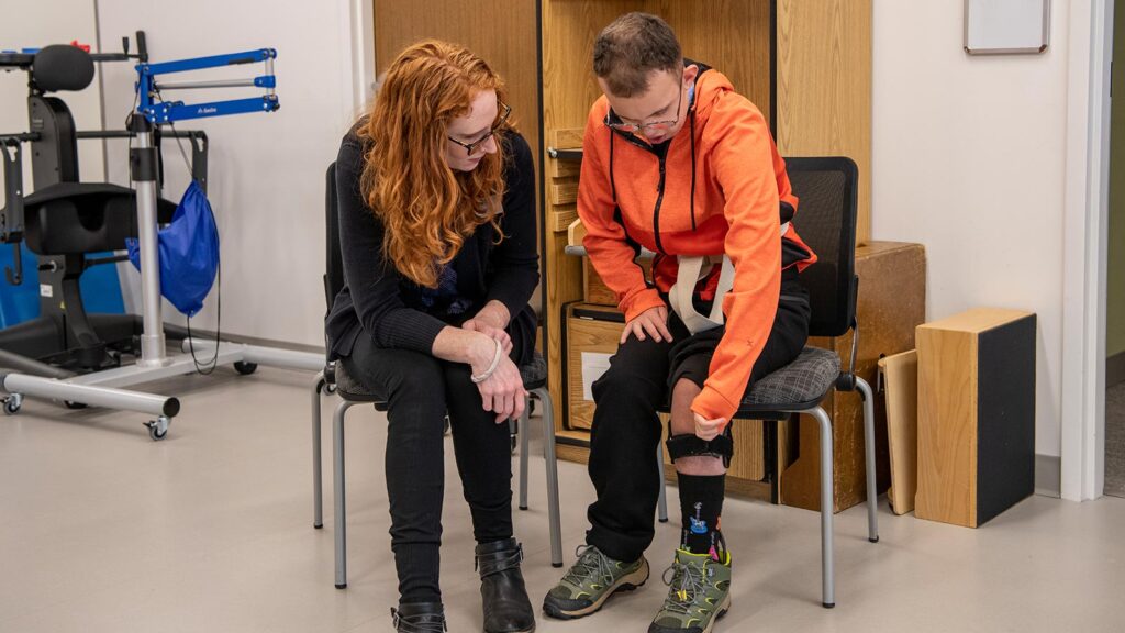 A Physical therapist talks to a client at the Maurice's clinic.