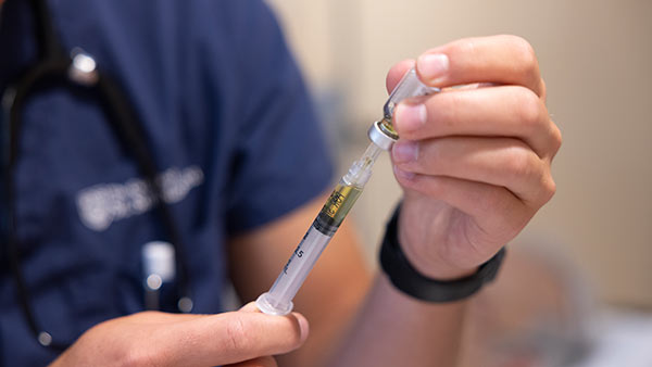 St. Scholastica Nursing student drawing medication for a patient.