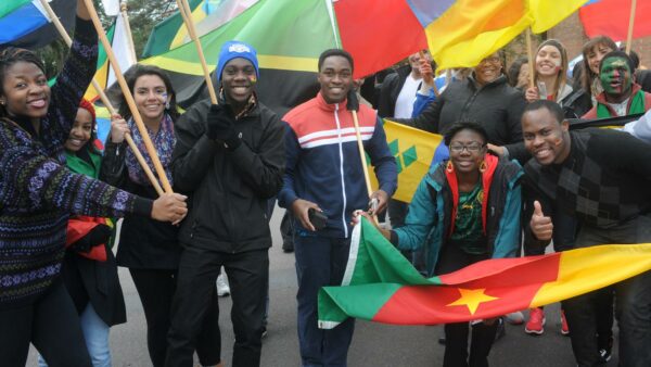 International Students marching in the St. Scholastica Homecoming Parade.