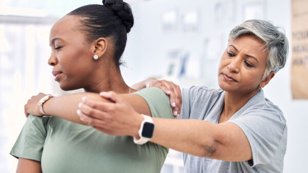 A physical therapist helping a client.