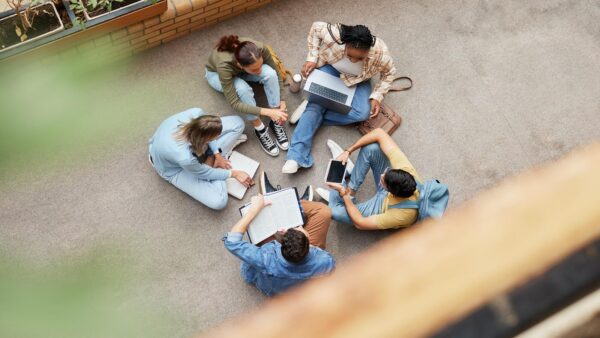 An overhead view of a group of students studying together in a courtyard.