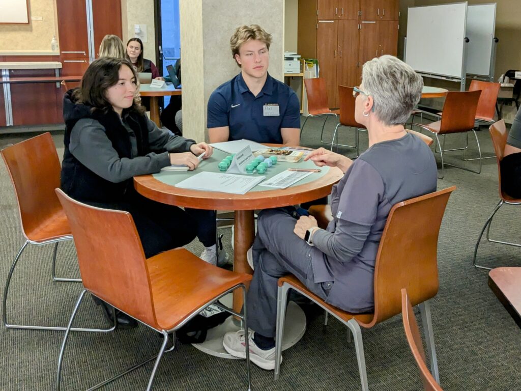 St. Scholastica students listen to a healthcare professional from Essentia Health.