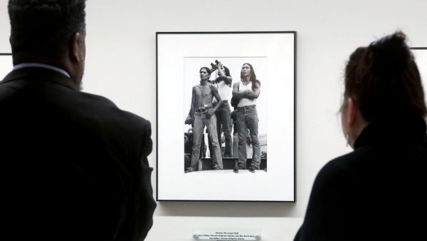 Two visitors look at the AIM Exhibit.